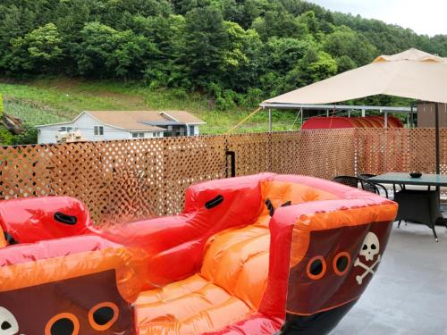 a couch with hello kitty pillows on a patio at Gapyeong Turu Kids Poolvilla in Gapyeong