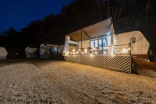 a house with lights on the side of it at night at Jade Byeolbit Caravan in Chuncheon