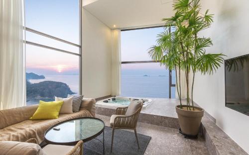 a living room with a view of the ocean at Byeonsan Barahan Pension in Buan