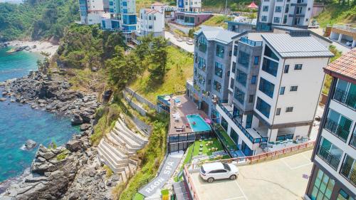 an aerial view of a city next to the ocean at Samcheok Laon Spa Pension in Samcheok