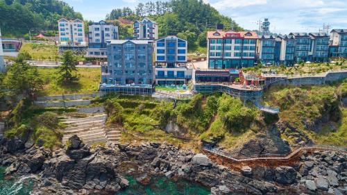 an aerial view of a city with buildings on a cliff at Samcheok Laon Spa Pension in Samcheok