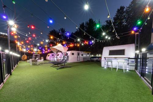 an outdoor patio with lights and chairs and a tent at Samcheo Tayo Caravan in Samcheok