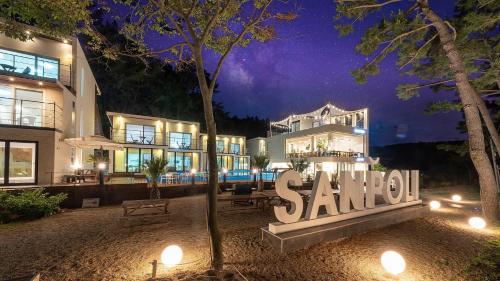 a building with a sanchez sign in front of it at night at Uljin sanpoli Pension in Uljin