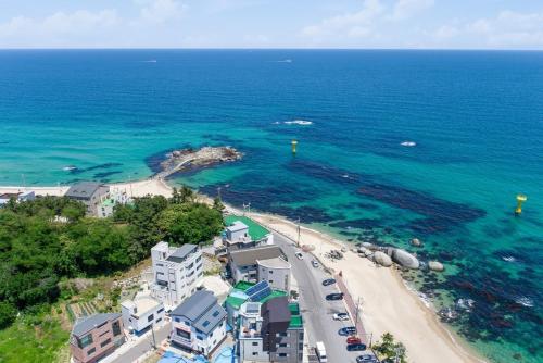 an aerial view of a beach and the ocean at Gangneung Blanc Beach Pension in Gangneung