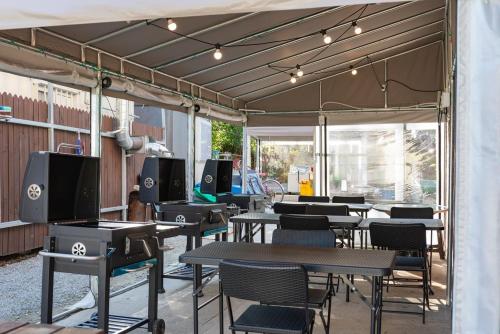 a group of tables and chairs in a patio at Gangneung Marine Park Pension in Gangneung