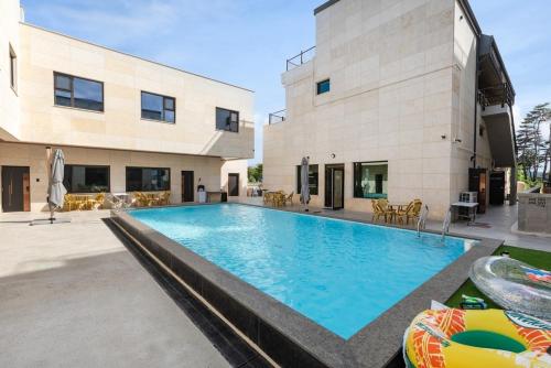 a large swimming pool in front of a building at Gangneung Stay in Gangneung in Gangneung