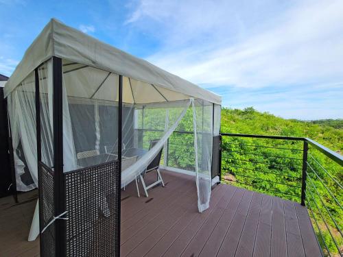 a gazebo with a canopy on a deck at Goseong Sunny Hill Pension in Goseong