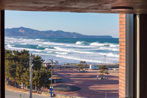a view of the beach from a window at Donghae Staypear471 in Donghae