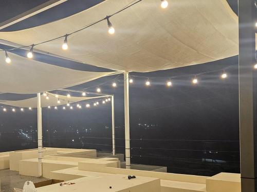 a white tent with lights and a view of the city at Goseong Stay Naru in Goseong
