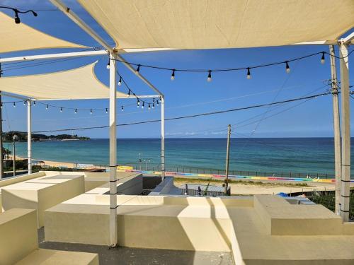 a view of the beach from under a tent at Goseong Stay Naru in Goseong