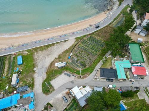an aerial view of a beach and the ocean at Goseong Stay Naru in Goseong