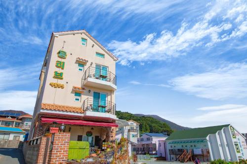 a building with a sign on the side of it at Geoje olive couple pension in Geoje 