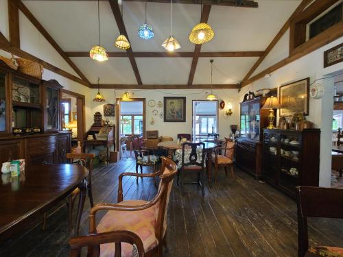 a dining room with wooden tables and chairs at Goseong Maris Pension in Goseong