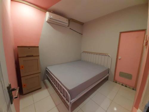 a small bedroom with a bed and a heater at New Jasmine in Karangtengah