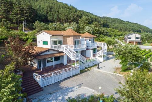 an aerial view of a house with a mountain at Gangneung Chunja Yeoinsook in Gangneung