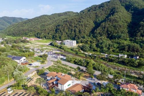 an aerial view of a village in the mountains at Gangneung Chunja Yeoinsook in Gangneung