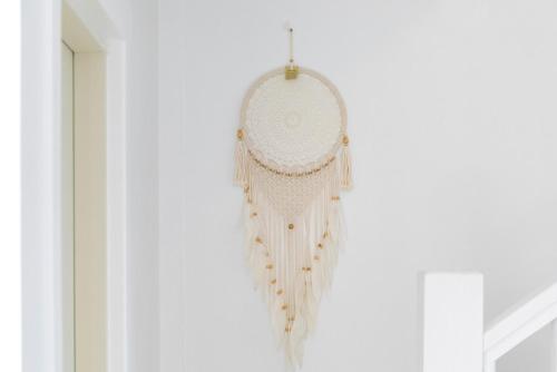 a white chandelier hanging from a white wall at Gyeongju Insta Spa Pension Spa, Individual BBQ in Gyeongju