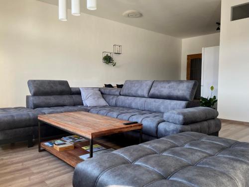 a living room with two couches and a coffee table at Apartmán na náměstí in Králíky