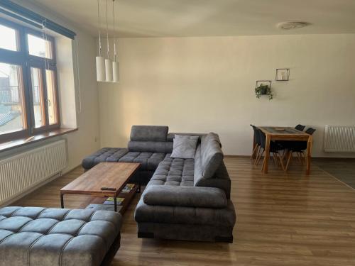 a living room with two couches and a table at Apartmán na náměstí in Králíky