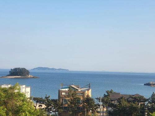 a view of the ocean and a building at Taean Gana Pension Pet friendly in Taean