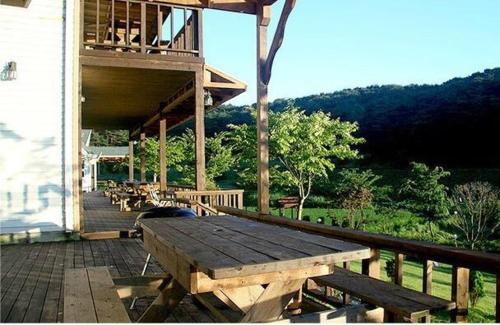 a deck with a wooden bench on a porch at Anmyeondo Lake Park Pension in Ch'anggi-ri