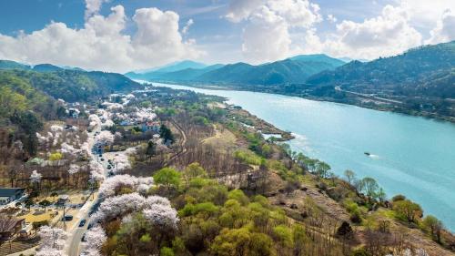an aerial view of a town next to a river at Gapyeong River Wave Pool Villa in Gapyeong
