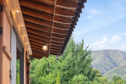 a window of a building with a view of a mountain at Hanok stay under the golden sky in Yangpyeong in Hŏnt'ŏbŏl