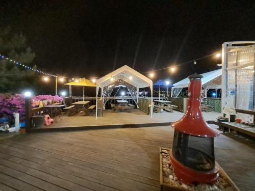 a bottle of wine sitting on a table in front of a tent at Pension 1830 in Taean