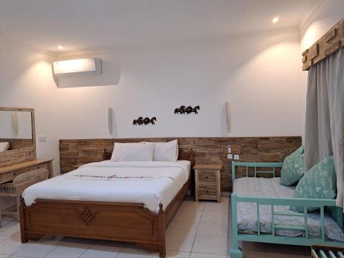 a bedroom with two beds in a room at Lavender star house in Kuta