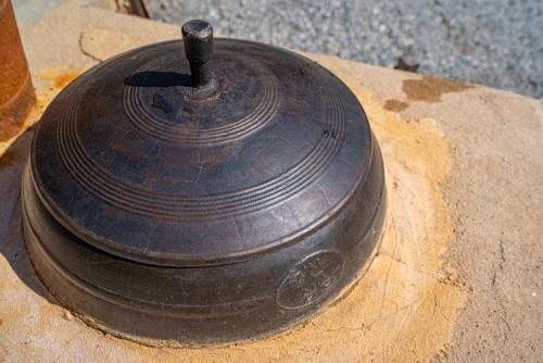 a black object sitting on top of a fire hydrant at Kim Satgat Heukjib Yiyagi in Yeongwol
