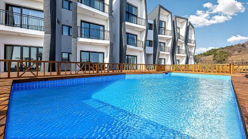 a large swimming pool in front of a building at Stonecove Pension in Geoje 