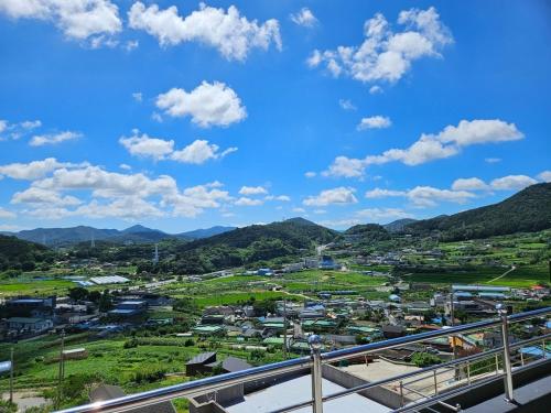 a view of a town with mountains in the background at Yeosu Art Village 705 Pension in Hagŭm