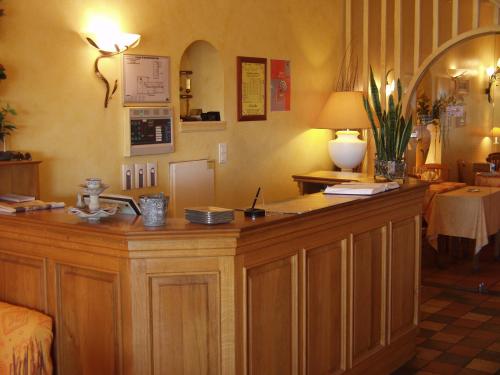 a room with a large wooden counter in a room at Hôtel L'Ecailler in La Cotinière