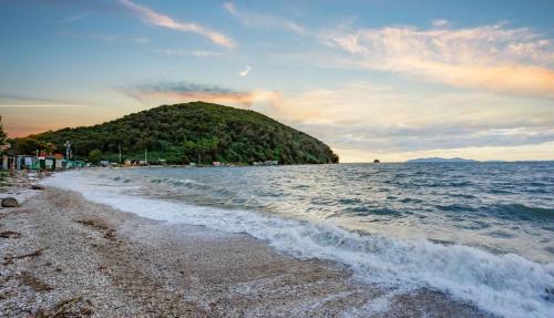 a beach with a small island in the water at Daebudo Ara Pension in Ansan