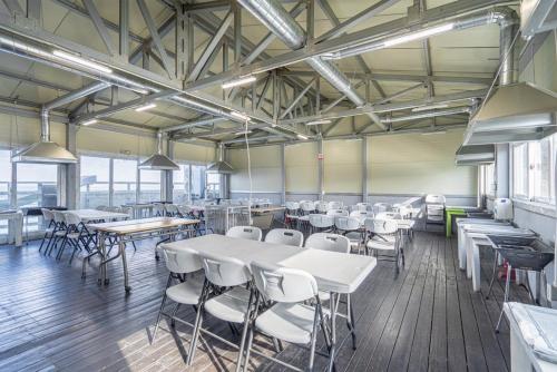 a room with tables and chairs in a building at Daebudo Ara Pension in Ansan