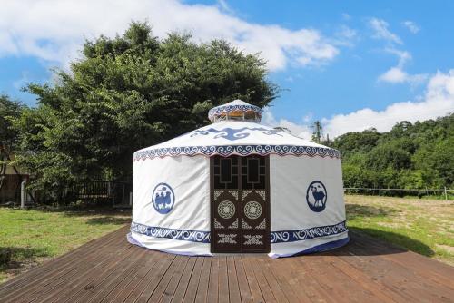 a yurt sitting on top of a wooden deck at Ulaanpak Caravan Camping Site in Gapyeong