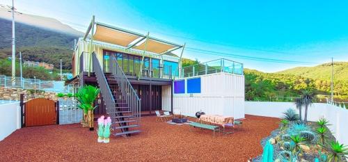 a house with a staircase in the middle of a yard at Stay the zion in Miryang