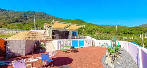 a house with a fence and a yard with chairs at Stay the zion in Miryang