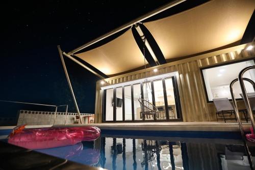 a swimming pool with a red raft in the water at Stay the zion in Miryang