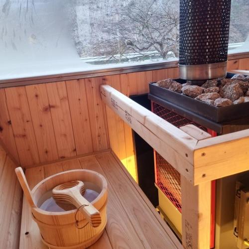 a kitchen with a stove and a shelf with food at Hongcheon Romantic Travel Pension in Hongcheon
