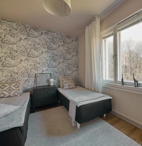 a bedroom with two beds and a window at 50s Atmospheric Suite in Turku