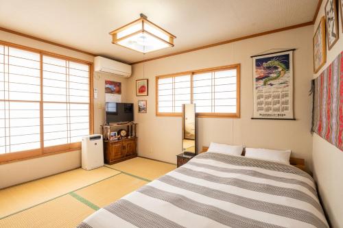 Cama o camas de una habitación en Asahi