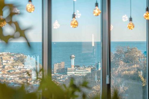 a view of a city from a window at Mazihouse in Mukho-dong
