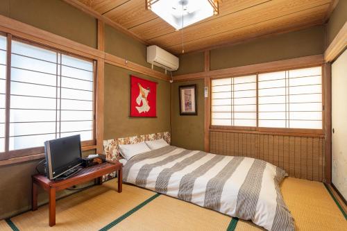 Cama o camas de una habitación en Asahi