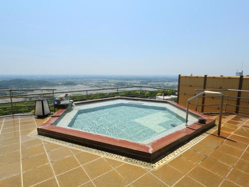 a swimming pool on the roof of a house at Tsukubasan Hotel Aokiya in Tsukuba