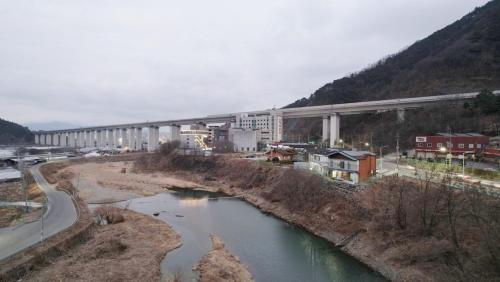 a bridge over a river next to a city at Gyeongsan Annex Pension in Gyeongsan