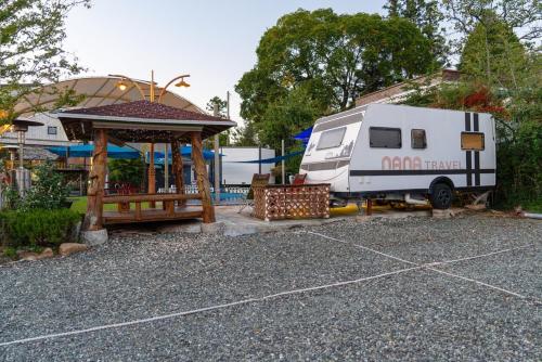 a white rv parked next to a gazebo at Suncheon Slow Pension in Suncheon
