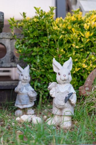 two statues of rabbits standing in the grass at Suncheon Slow Pension in Suncheon