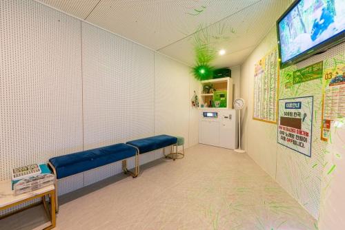 a waiting room with a blue bench in a hospital at Suncheon Slow Pension in Suncheon