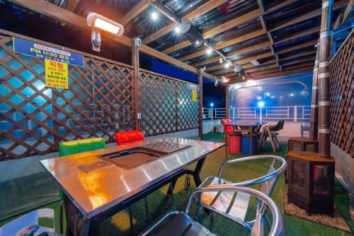 a restaurant with a table and chairs in a room at Suncheon Slow Pension in Suncheon